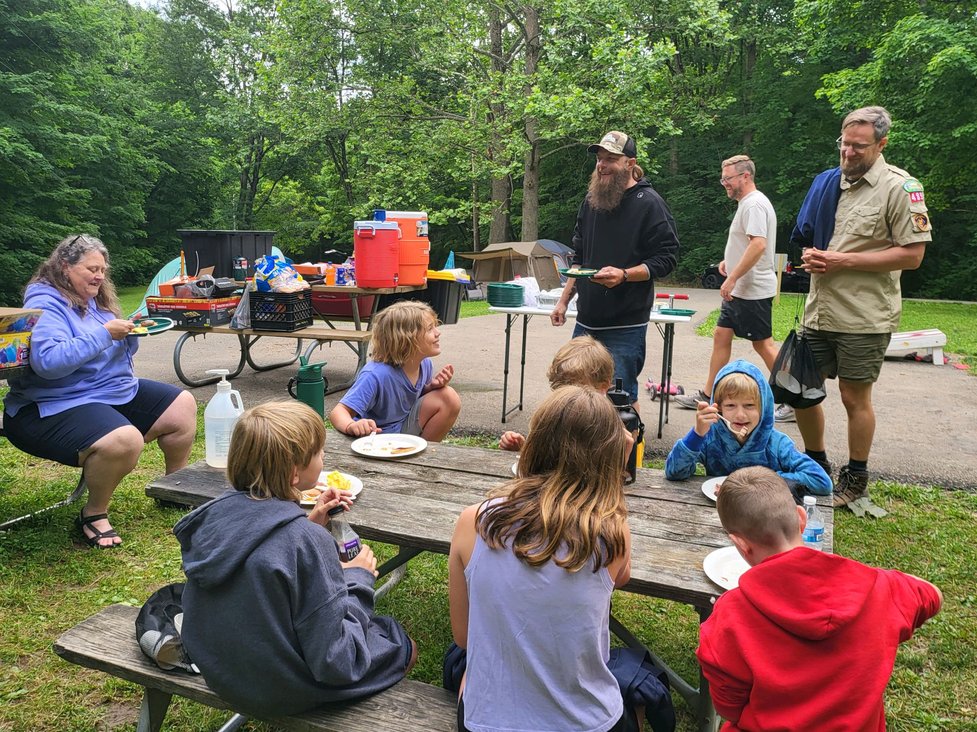 Scouts and families sharing a meal at camp