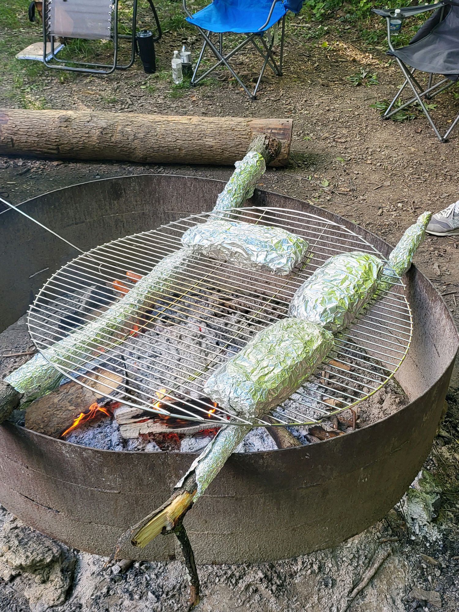Foil dinners cooking over a campfire